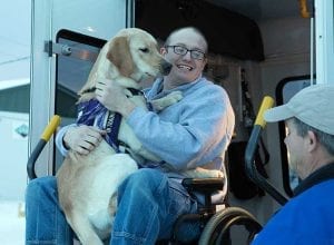 Mark, an army medic at Ft Wainwright, volunteers as a dog handler during service dog-in-training Buck’s first bus ride.