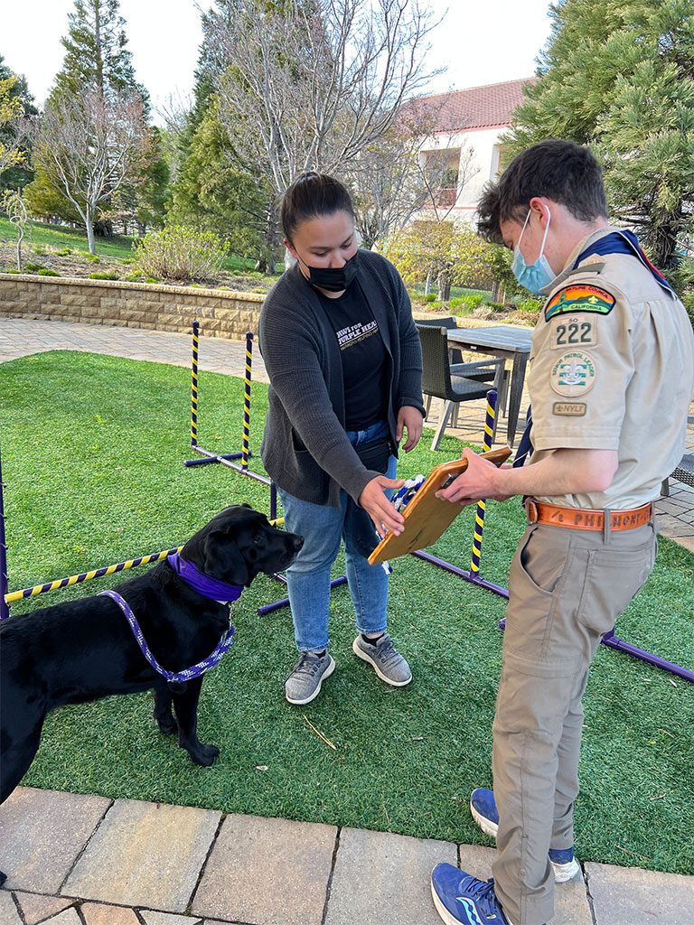 Boy Scout, Jared, showing Program Instructor, Megan, the new training equipment